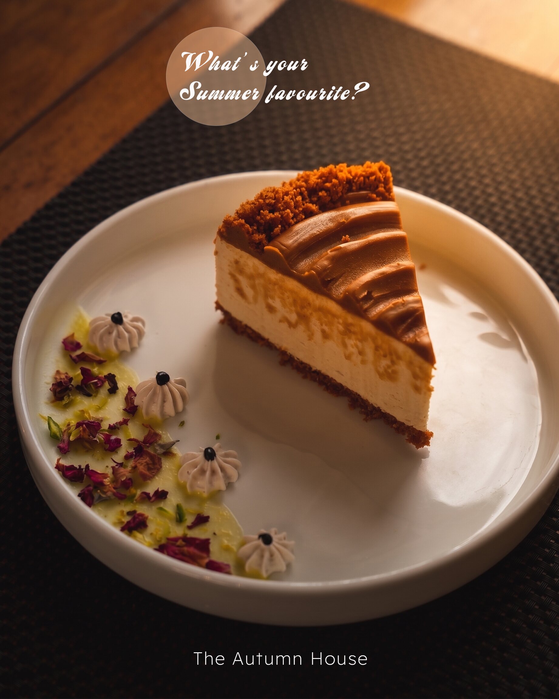 A slice of cheesecake with a biscuit base on a white plate