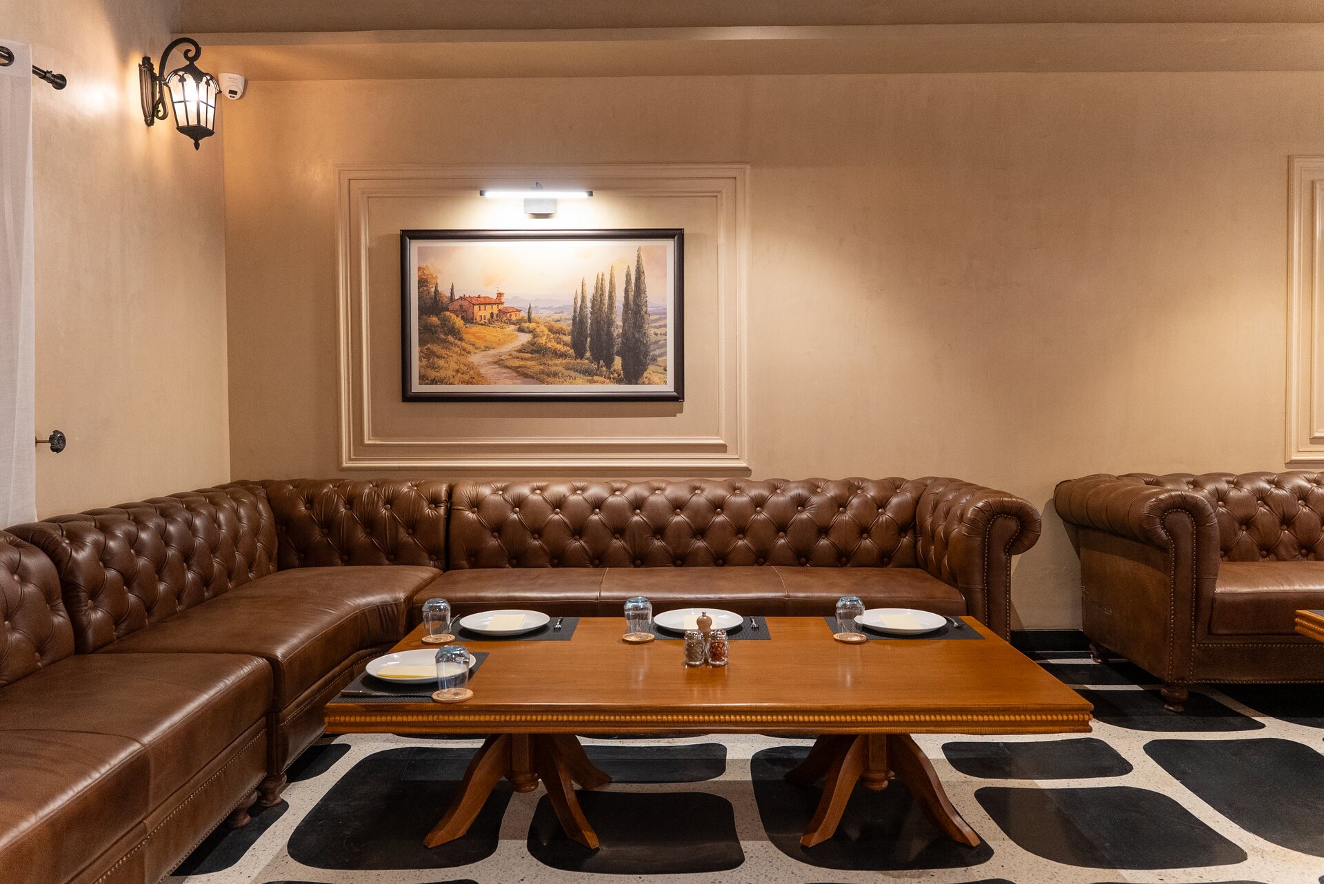 A corner lounge at Delhi with chesterfield sofas around a low wooden table